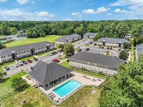 Hope Mills apartment for rent - A bird's eye view of a resort with a swimming pool and multiple buildings.