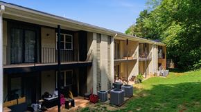 Winston Salem apartment for rent - A sunny day at a residential complex with people enjoying the outdoors.