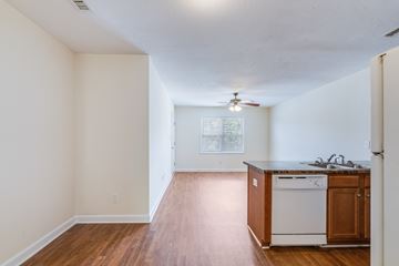 Hope Mills apartment for rent - A kitchen with white appliances and wooden cabinets.