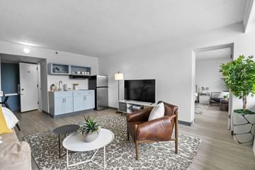 Fayetteville apartment for rent - A living room with a brown leather chair and a white coffee table.