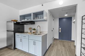 Fayetteville apartment for rent - A kitchen with a sink, refrigerator, and cabinets.
