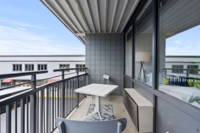 Fayetteville apartment for rent - A balcony with a table and chairs overlooking a cityscape.