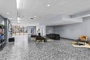 Burlington apartment for rent - A spacious room with a grey floor and furniture.