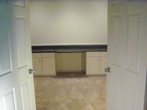 Durham apartment for rent - A white door is open to a room with a bench and cabinets.