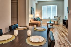 Norfolk apartment for rent - A dining room with a long table set for a meal.