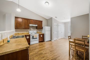 Concord apartment for rent - A kitchen with wooden cabinets and a white fridge.