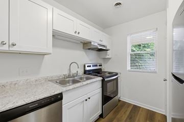 Winston Salem apartment for rent - A kitchen with white cabinets and a granite countertop.