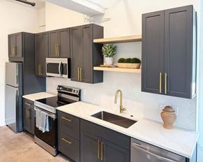 Asheville apartment for rent - A kitchen with dark brown cabinets and a white countertop.