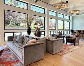 Asheville apartment for rent - A living room with a grey sofa and a wooden floor.