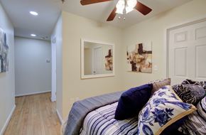 Lynchburg apartment for rent - A bedroom with a bed and a ceiling fan.