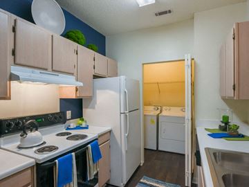 Asheville apartment for rent - A kitchen with a white stove top oven and white refrigerator.