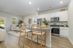 Longs apartment for rent - A kitchen with a table and chairs in front of it.