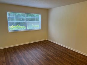 Winston Salem apartment for rent - an empty living room with wood floors and a window