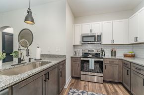 Winston Salem apartment for rent - a kitchen with white cabinets and granite countertops
