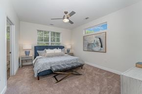 Winston Salem apartment for rent - a bedroom with a bed and a ceiling fan