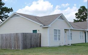 Fayetteville apartment for rent - A house with a grey roof and a wooden fence.