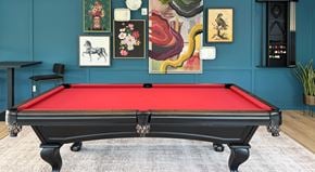Asheville apartment for rent - A pool table with a red cloth and white cue ball.