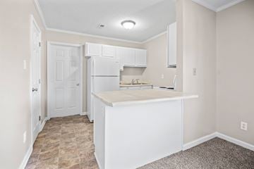 Fayetteville apartment for rent - A kitchen with white cabinets and a countertop.