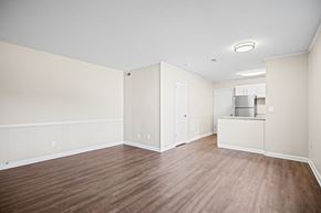 Fayetteville apartment for rent - A room with wood flooring and a refrigerator.