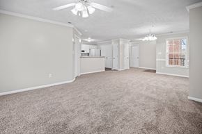 Fayetteville apartment for rent - A spacious room with a ceiling fan and carpeted floor.