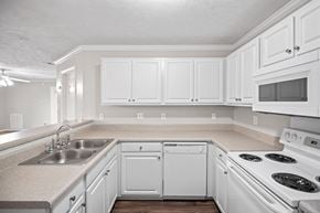 Fayetteville apartment for rent - A kitchen with white cabinets and appliances.