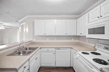 Fayetteville apartment for rent - A kitchen with white cabinets and appliances.