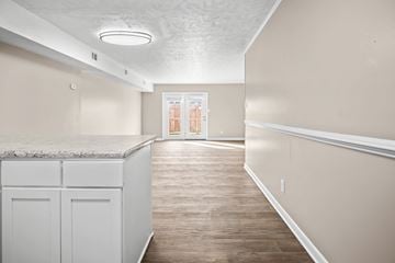 Fayetteville townhouse for rent - A kitchen with white cabinets and a marble countertop.