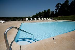 Winston Salem apartment for rent - A pool with a ladder and chairs around it.