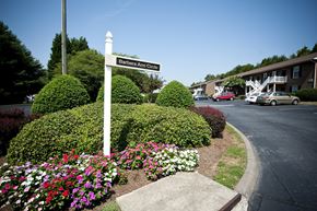 Winston Salem apartment for rent - A street sign for Barbara Ann Circle stands in front of a flower bed.