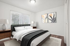 Durham apartment for rent - A bedroom with a large bed and two lamps.