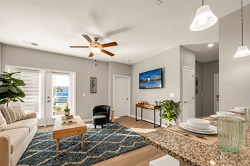Myrtle Beach apartment for rent - A living room with a ceiling fan and a painting on the wall.