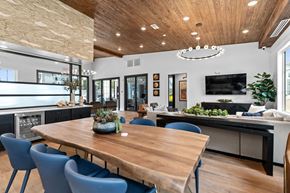 Fayetteville townhouse for rent - A modern dining room with a wooden table and blue chairs.