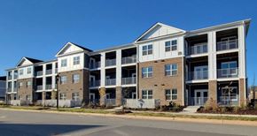 Kernersville apartment for rent - A large apartment complex with multiple balconies and doors.