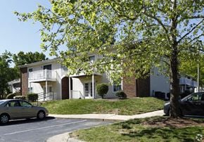 Cary apartment for rent - a white house with a car parked in front of it