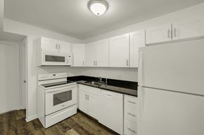 Durham apartment for rent - A kitchen with white appliances and cabinets.