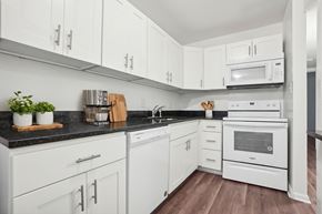 Durham apartment for rent - A kitchen with white cabinets and appliances.