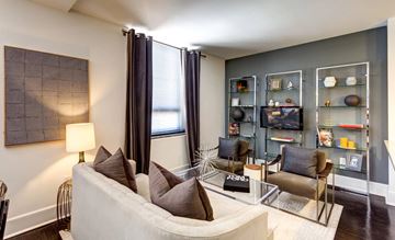 Norfolk apartment for rent - A living room with a white couch and a painting on the wall.