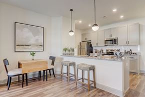 Asheville apartment for rent - A kitchen with a table and chairs and a framed picture on the wall.