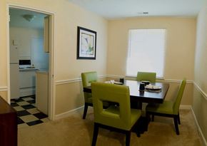 Winston-Salem apartment for rent - View of dining room model with square table and four green chairs
