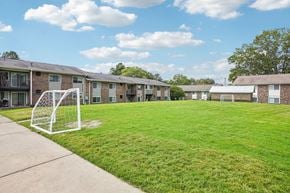 Durham apartment for rent - A soccer goal stands in the middle of a grassy area in front of apartment buildings.