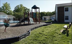 Cary apartment for rent - a playground with a swing set in a yard