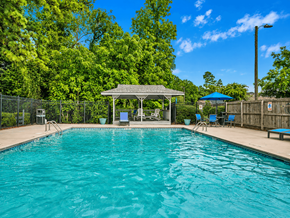 Fayetteville apartment for rent - A swimming pool with a gazebo and chairs around it.