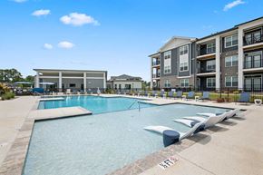 Fayetteville townhouse for rent - A swimming pool with a building in the background.
