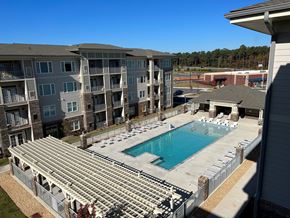 Clayton apartment for rent - an aerial view of a swimming pool in front of an apartment building