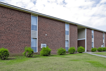 Fayetteville apartment for rent - A brick building with a sign on it.