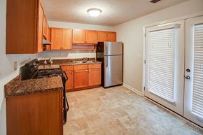 Fayetteville apartment for rent - A kitchen with wooden cabinets and a granite countertop.
