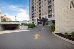 Ottawa apartment for rent - an empty parking lot in front of an apartment building with an arrow painted on it