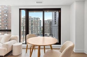 Ottawa apartment for rent - a dining room with a table and chairs in front of a window