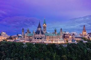 Ottawa apartment for rent - A large, ornate building with a green roof is the focal point of the image.