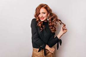 Ottawa apartment for rent - a young woman with red hair leaning against a white wall